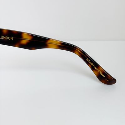 a pair of sunglasses sitting on top of a white table