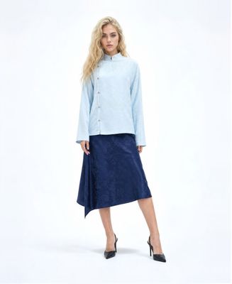 a woman in a blue shirt and skirt