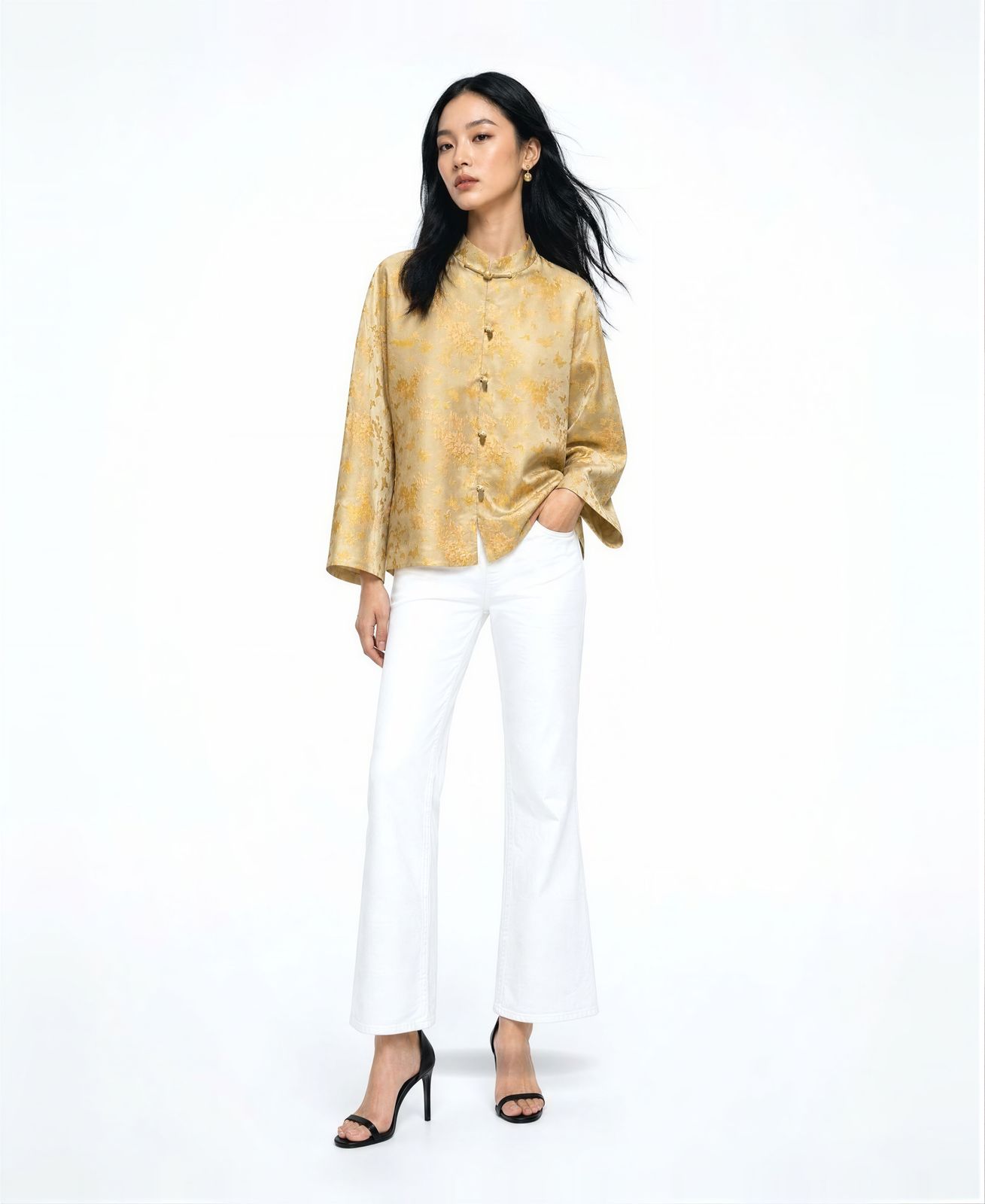 a woman in a yellow shirt and white pants