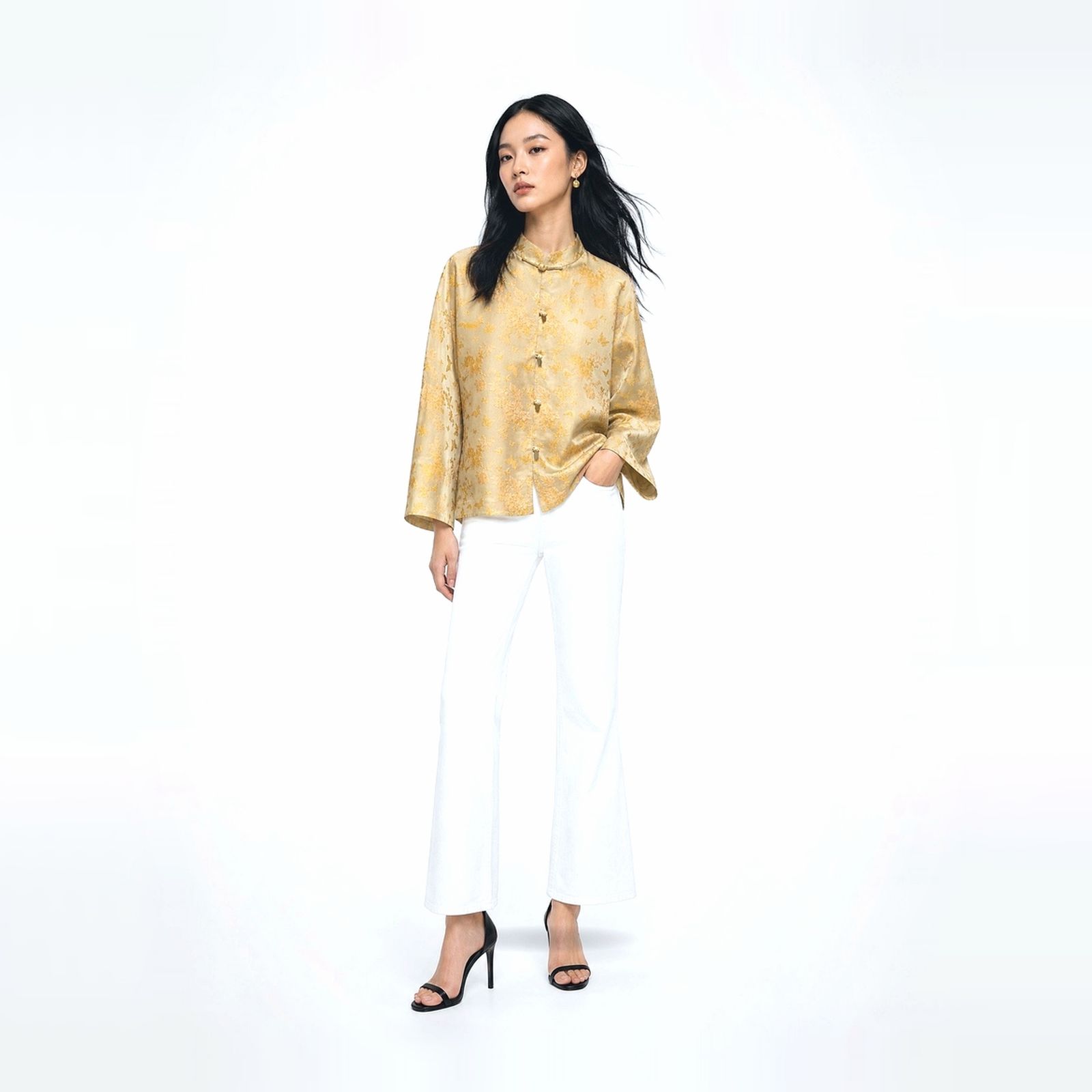 a woman standing in front of a white background