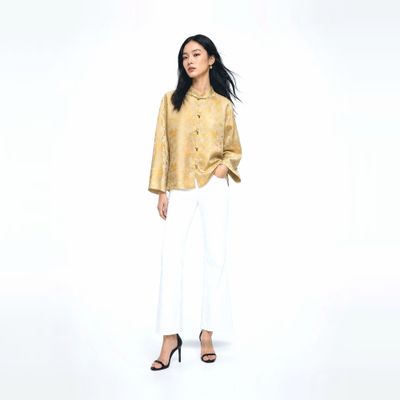 a woman standing in front of a white background