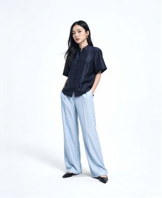 a woman standing with her hands on her hips