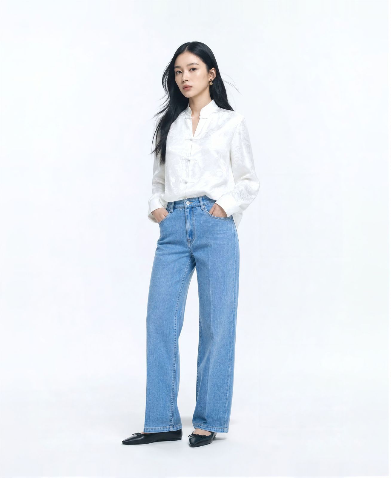 a woman standing with her hands in her pockets