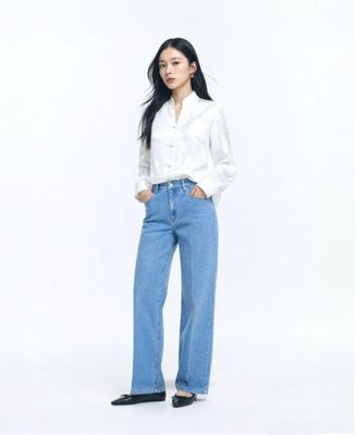 a woman standing with her hands in her pockets