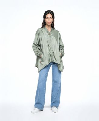 a woman wearing a green shirt and jeans