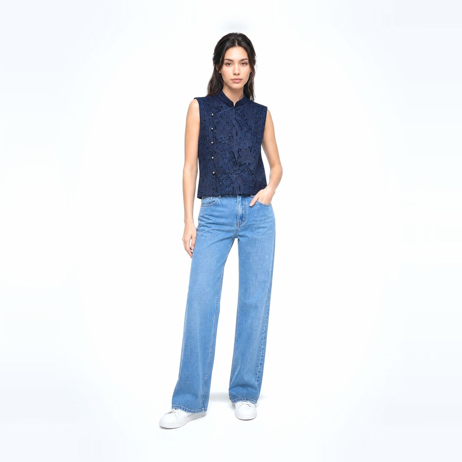 a woman wearing a blue shirt and jeans