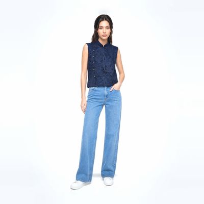 a woman wearing a blue shirt and jeans