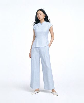 a woman in a blue top and pants