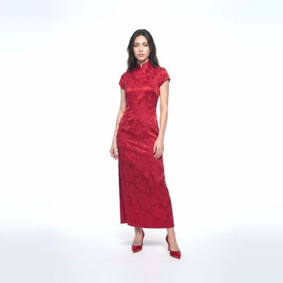 a woman in a red dress standing in front of a white background