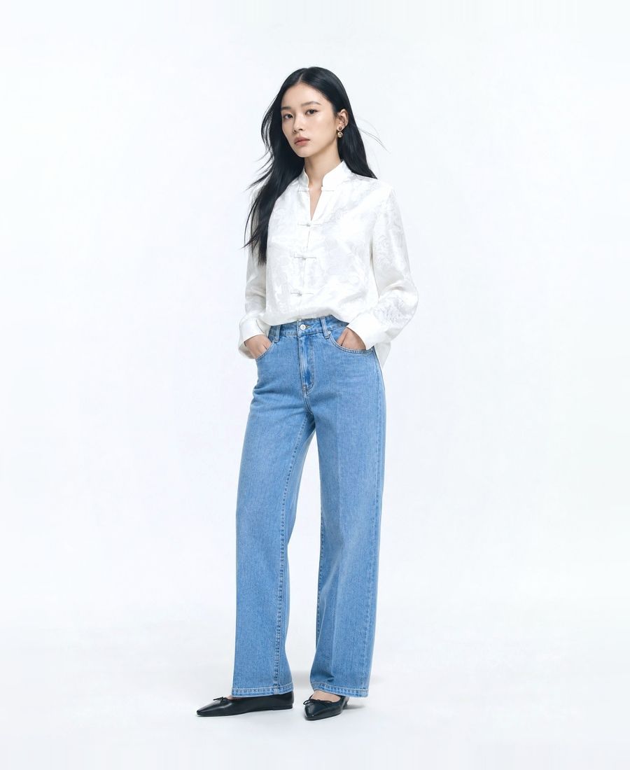 a woman standing with her hands in her pockets