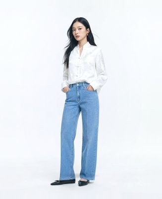 a woman standing with her hands in her pockets