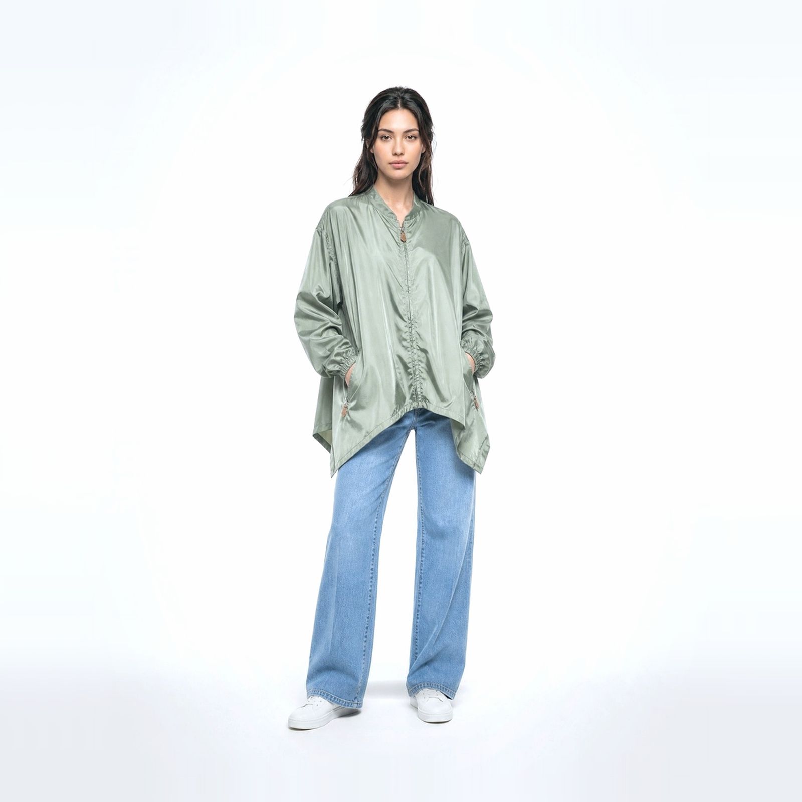 a woman in a green shirt and jeans