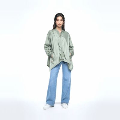 a woman in a green shirt and jeans