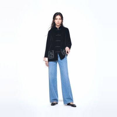 a woman in a black jacket and jeans