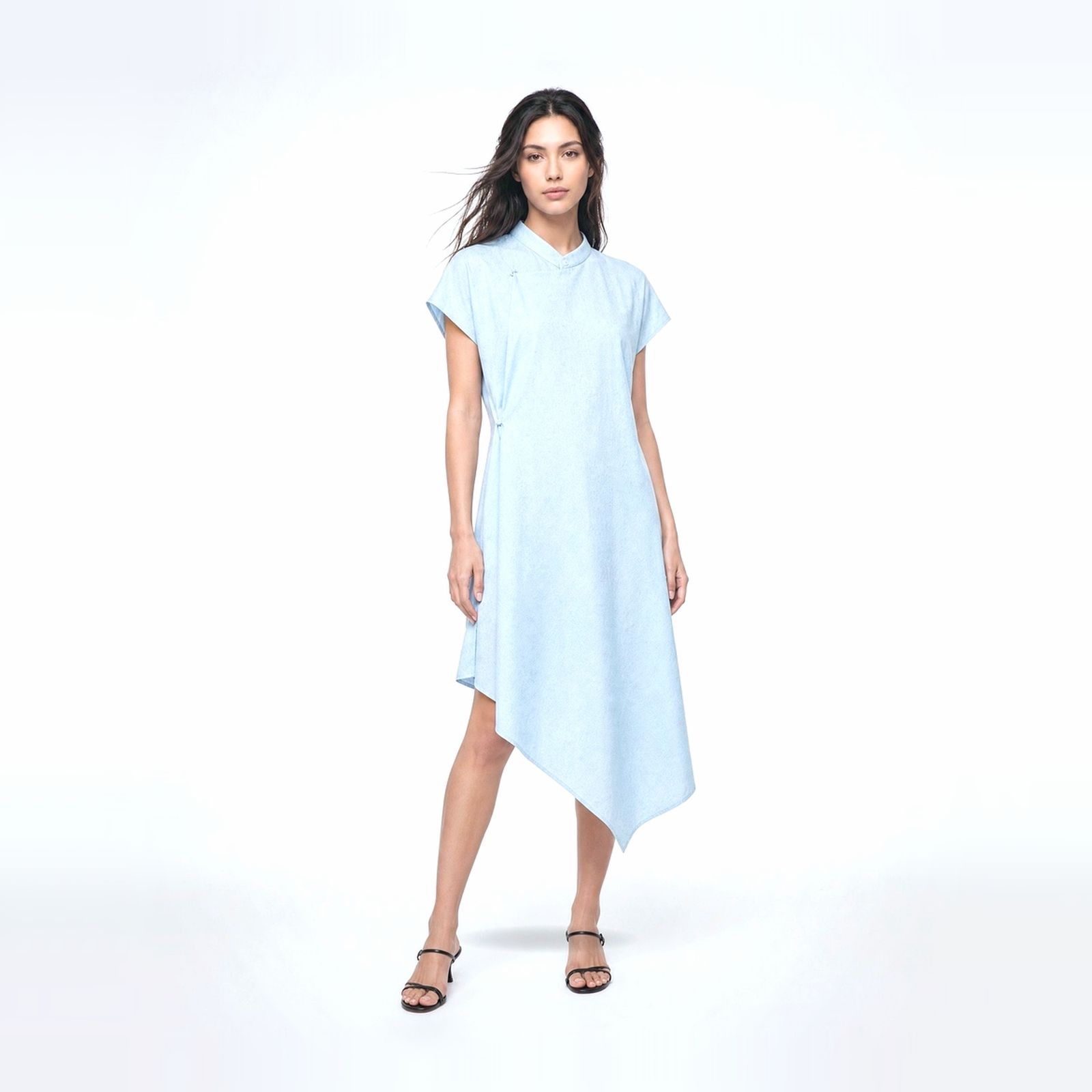 a woman wearing a blue dress and sandals