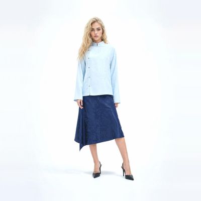 a woman in a blue shirt and a blue skirt
