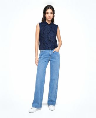 a woman in a blue shirt and jeans