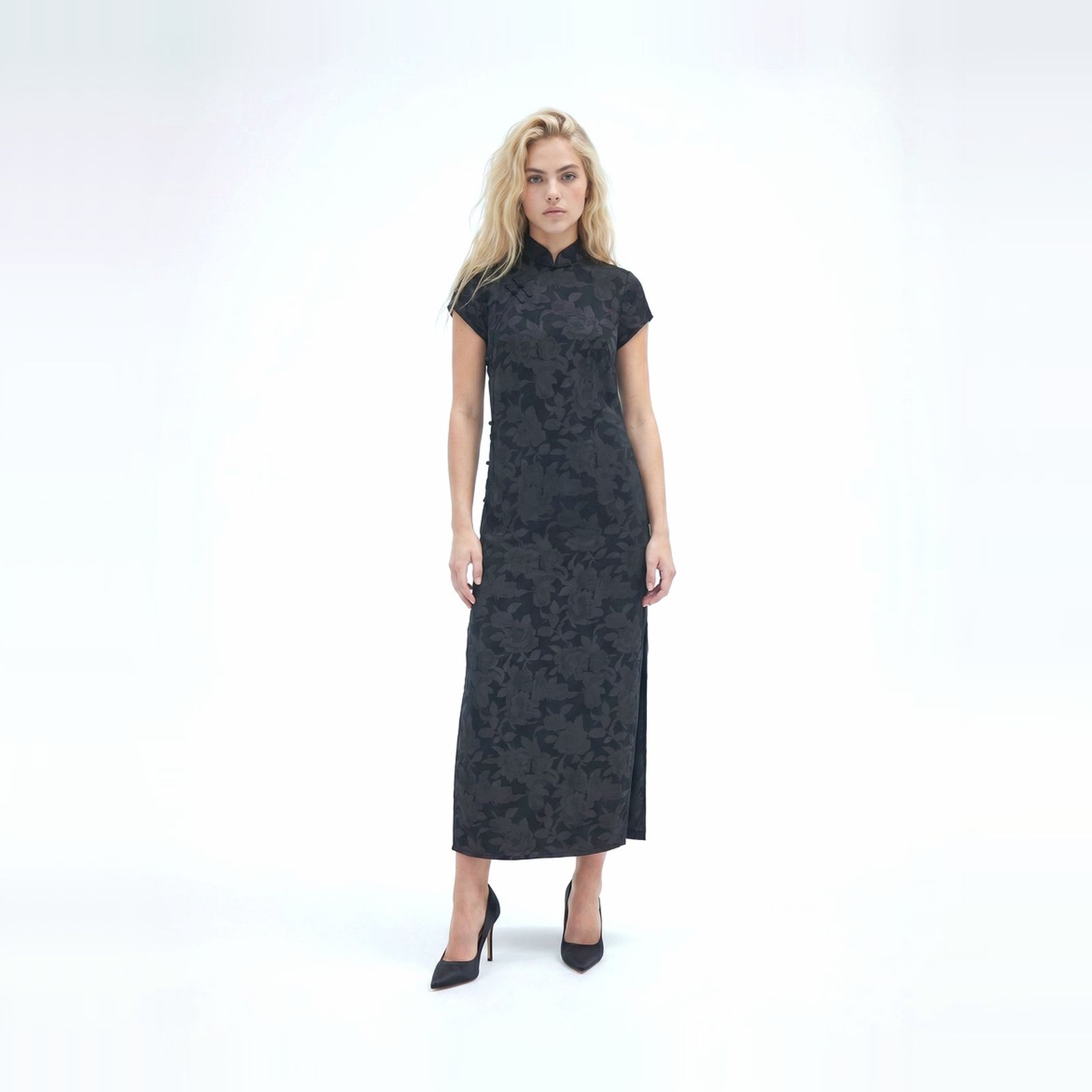 a woman in a black dress is posing for a picture