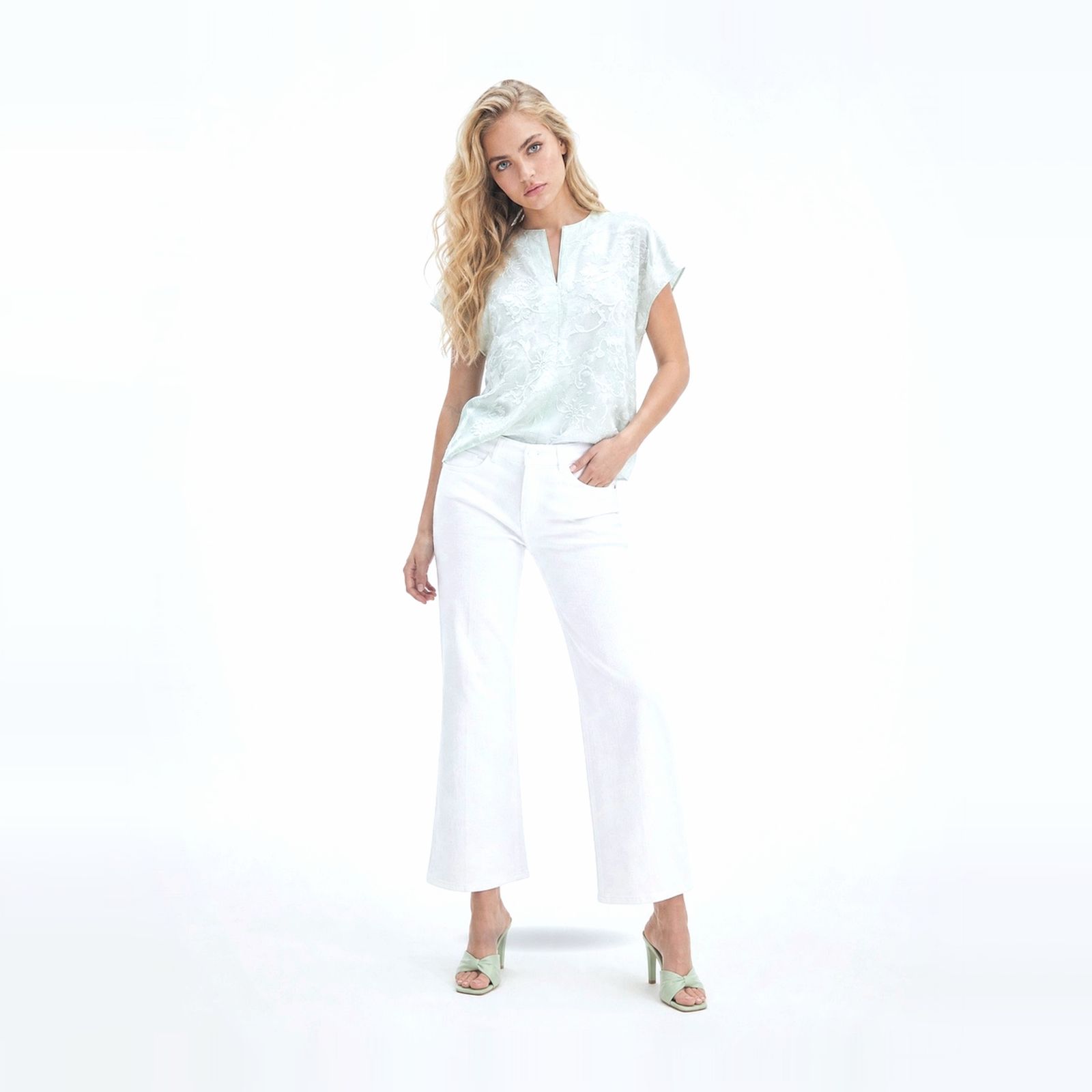 a woman in a white top and white pants