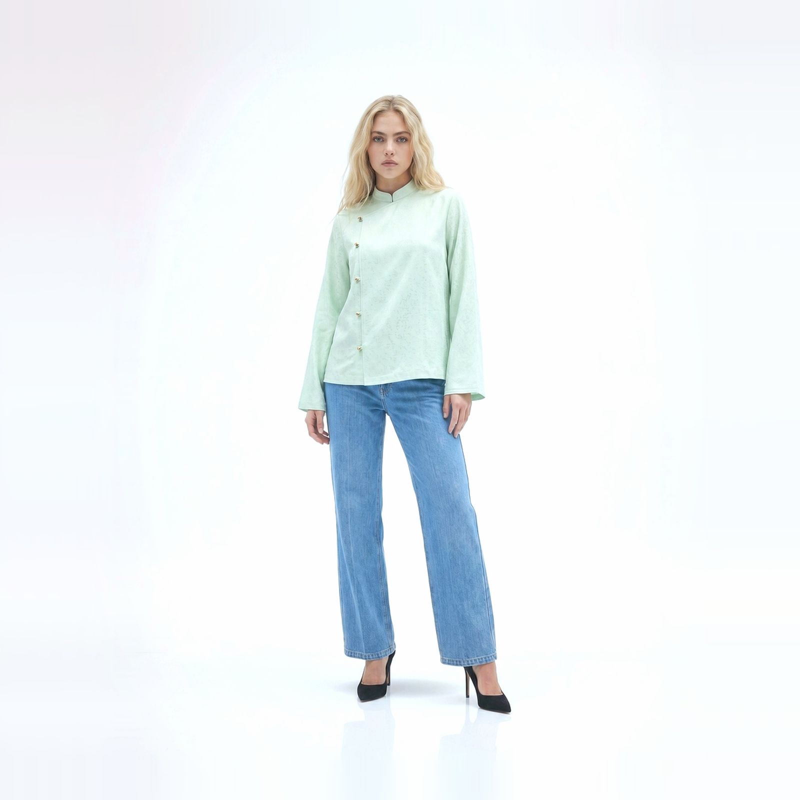 a woman in a light green shirt and jeans