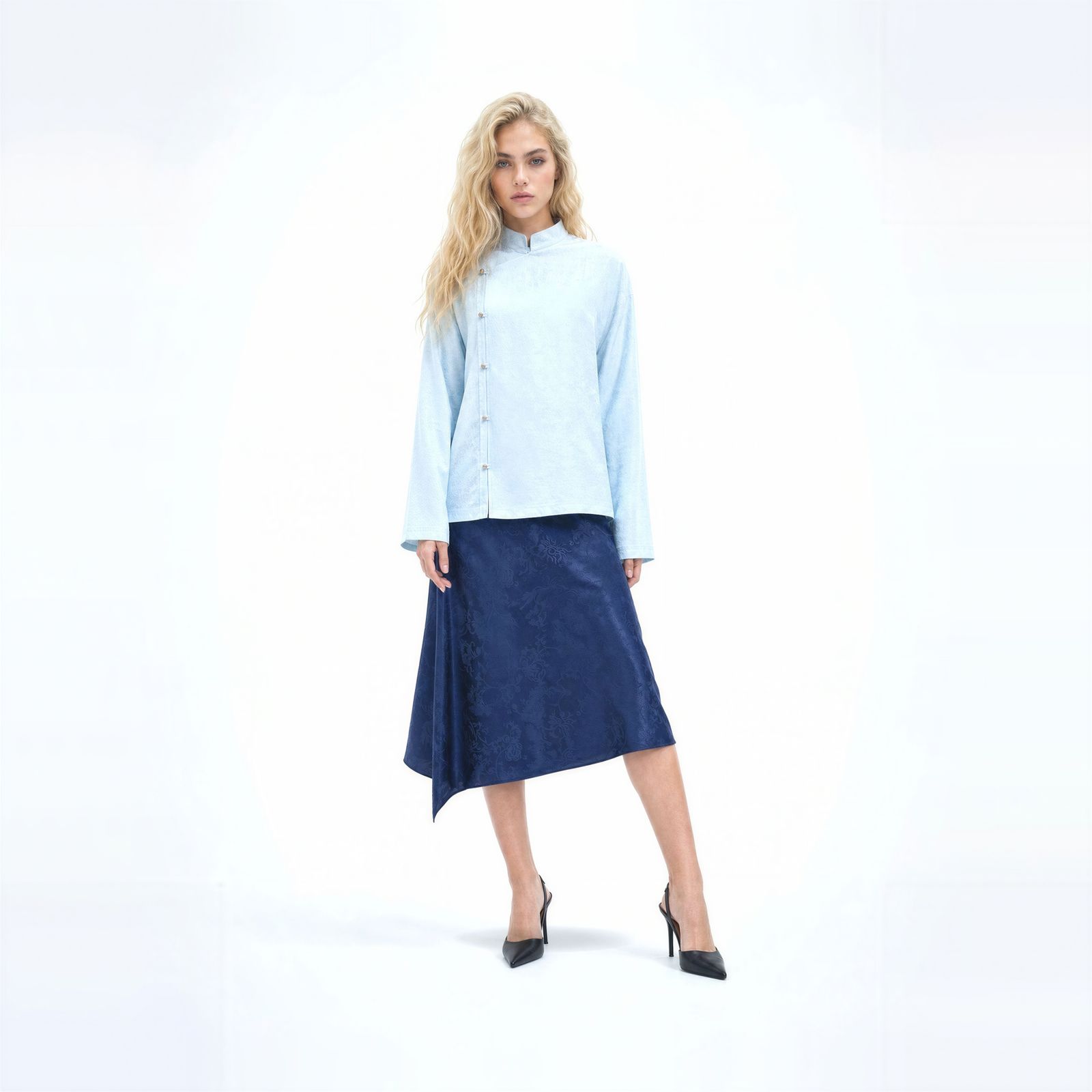 a woman in a blue shirt and a blue skirt