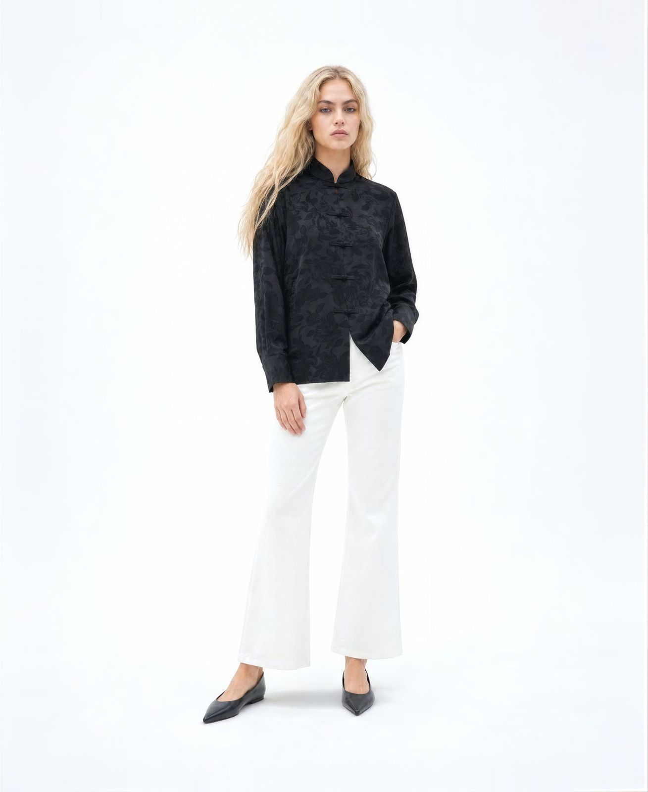 a woman in a black shirt and white pants