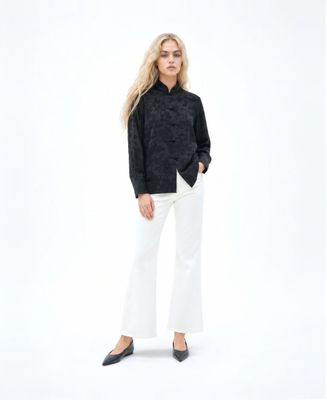 a woman in a black shirt and white pants