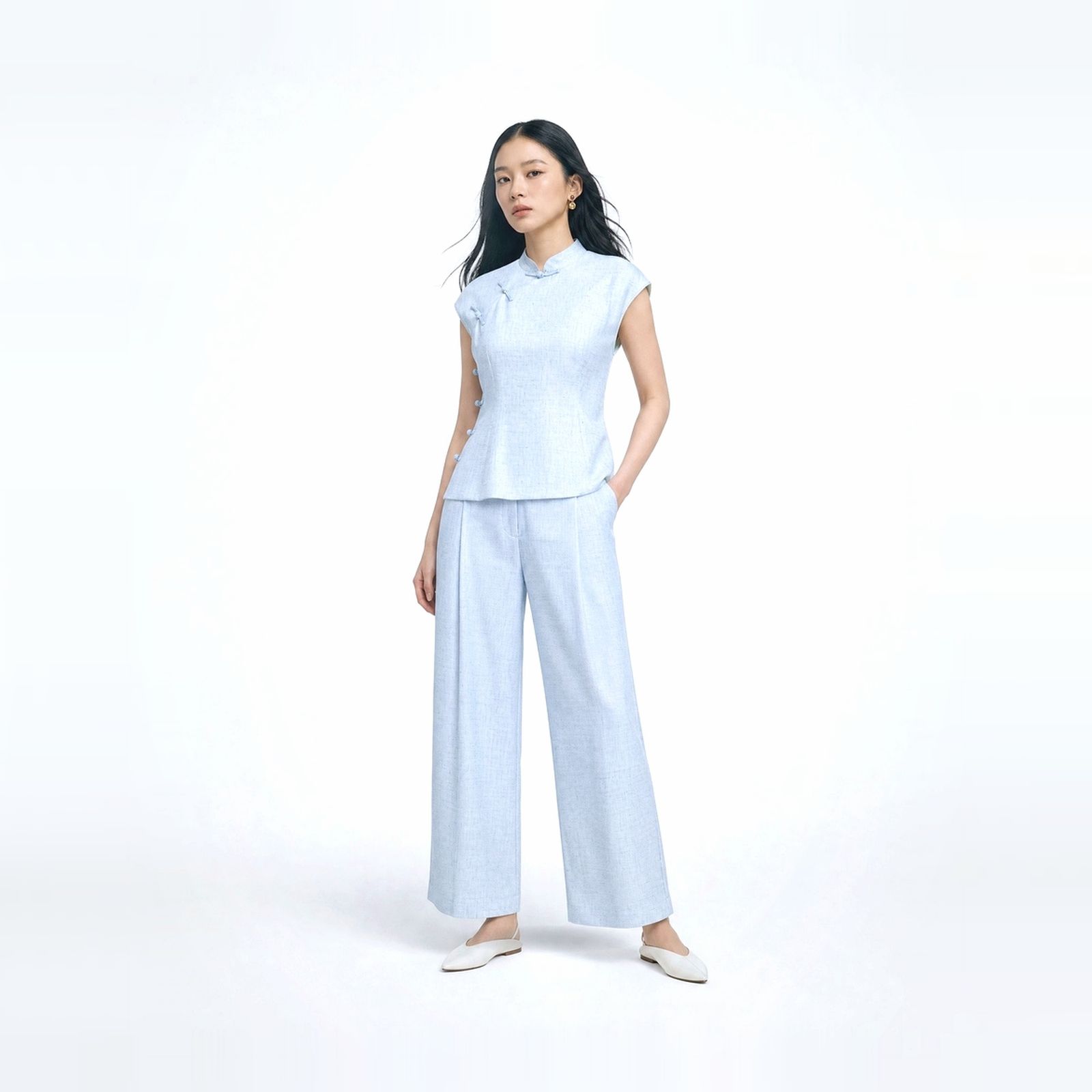 a woman in a white top and blue pants