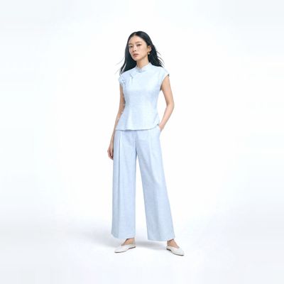 a woman in a white top and blue pants