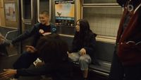 a group of people sitting on a subway train