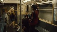 a group of people riding on a subway train