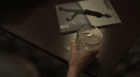 a person holding a glass of water on a table