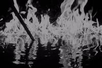 a black and white photo of fire and water