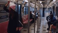 a group of people riding on a subway train