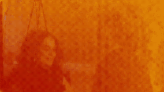 a blurry image of a woman walking down a street