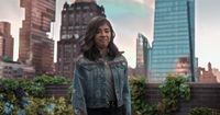 a woman standing in front of a city skyline