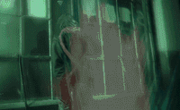 a blurry image of a person standing in front of a window