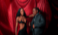 a blurry image of a man and a woman dancing