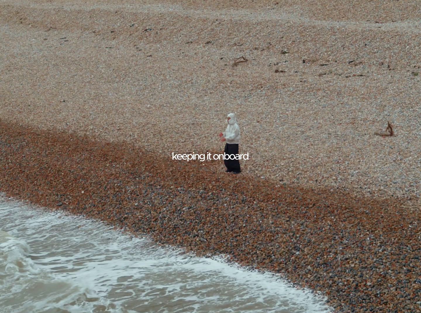 a person standing on a beach next to the ocean