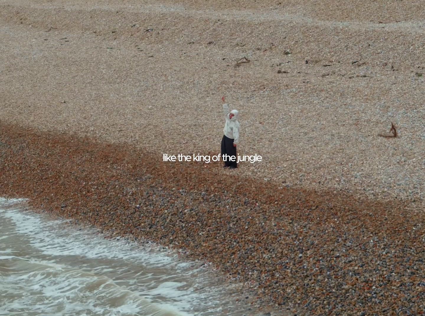 a man standing on a beach next to the ocean