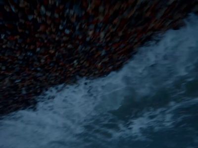 a group of people standing on top of a boat in the ocean