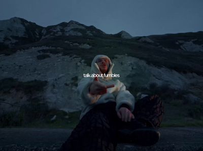 a person sitting on a rock in the dark