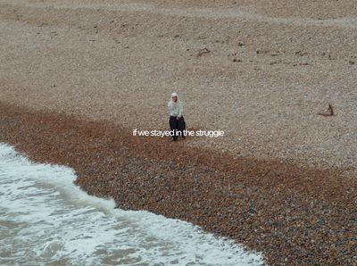 a man standing on a beach next to the ocean