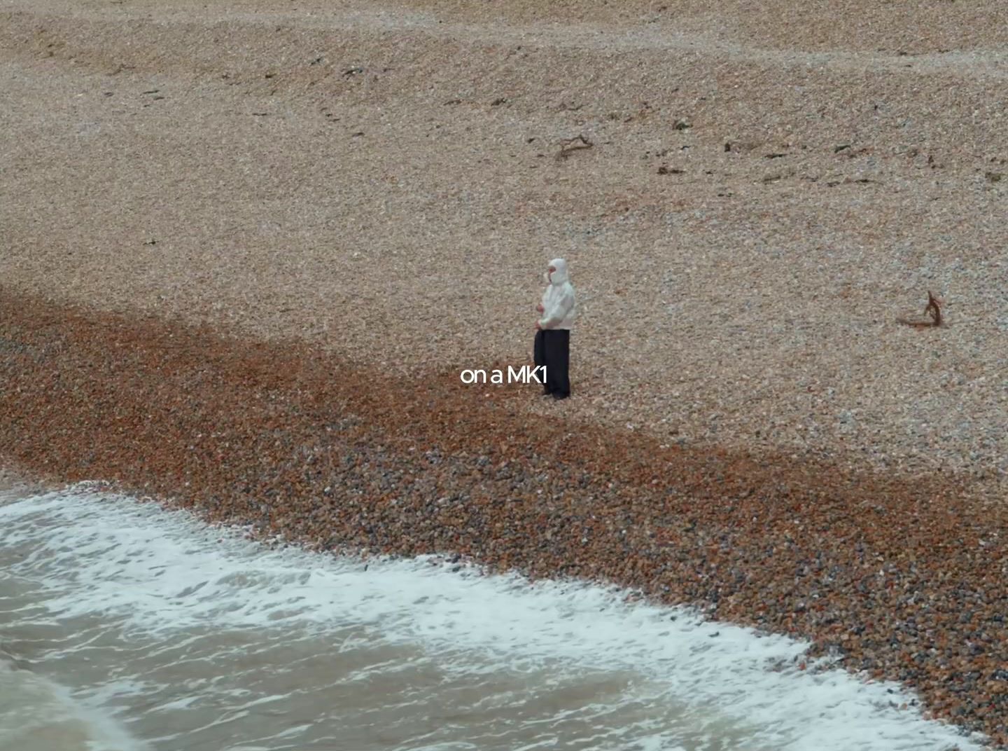 a person standing on a beach next to the ocean