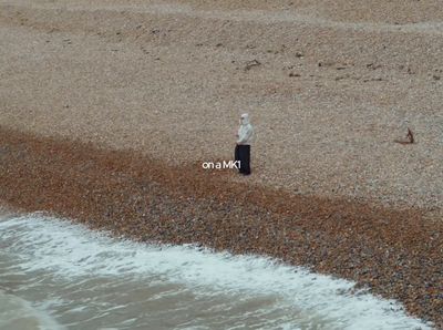 a person standing on a beach next to the ocean