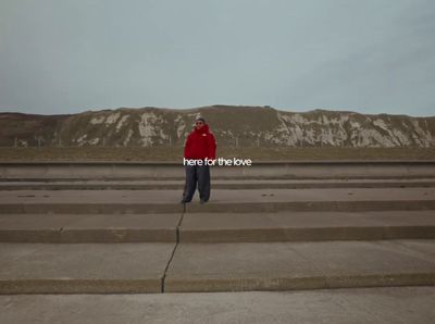 a person in a red jacket is standing on some steps