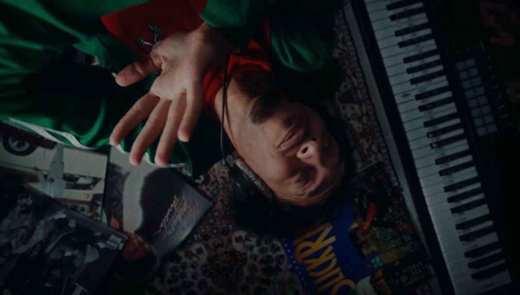 a man laying on the ground next to a keyboard