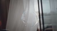 a bubble floating in front of a window