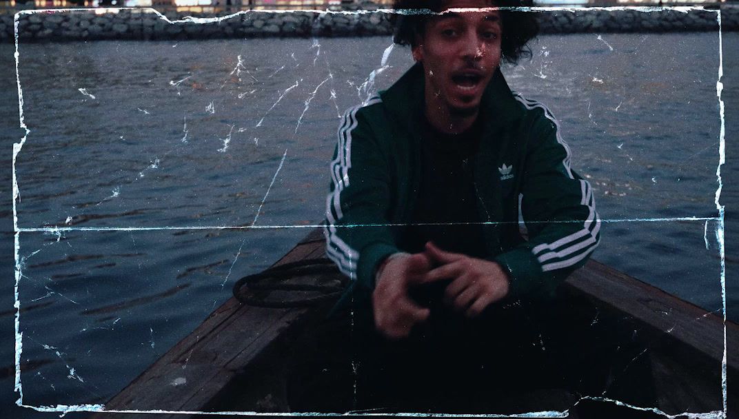 a man sitting in a boat on a body of water