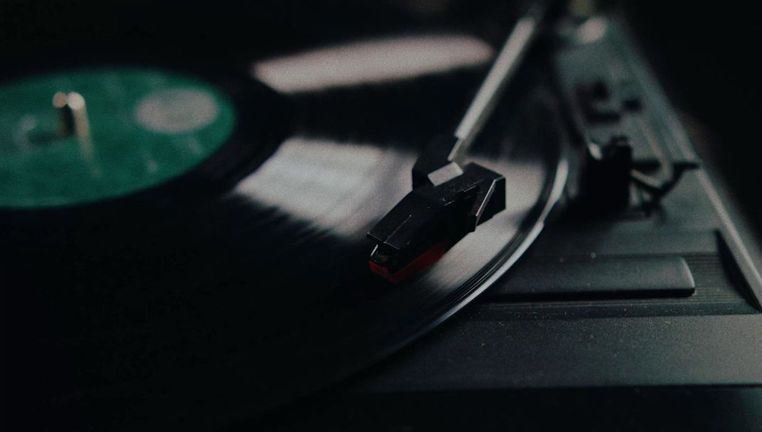 an old record player with a green disk